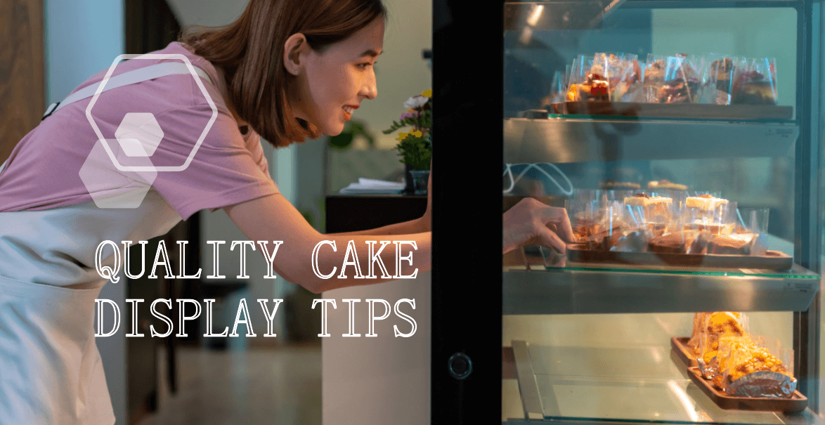 A person wearing a pink shirt and white apron is arranging cakes inside a glass display case. The text Quality Cake Display Tips is prominently displayed on the image. The cakes are individually wrapped and placed on trays within the display case. This image is relevant to the blog post titled Key Components of Cake Display: Ensuring Quality and Customization for Your Business.